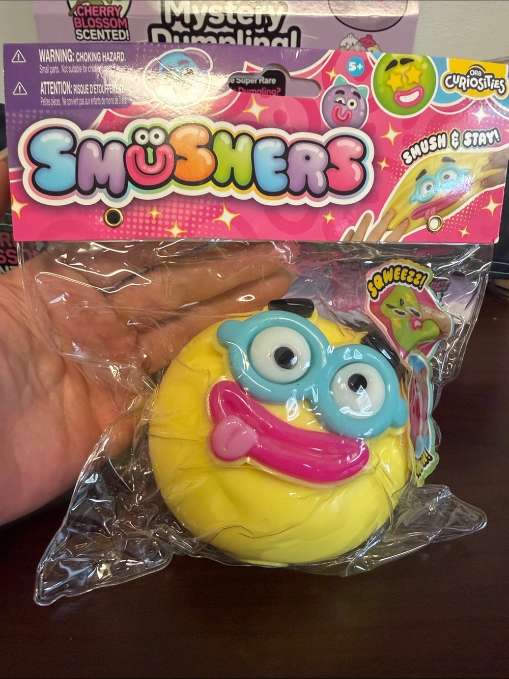 Smushers Yellow Laughing Face Squishy Toy with Blue Glasses by Orb